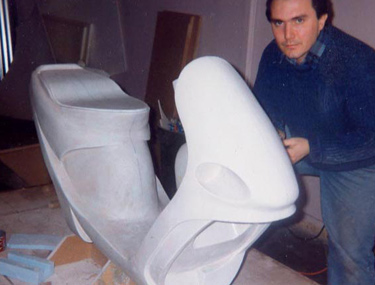 Working 
      
 
 
 
 on a full-size model of a scooter.